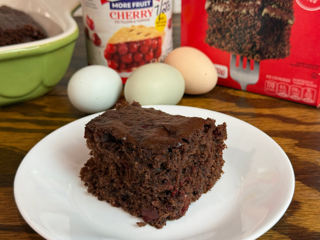 Slice of 3 ingredient chocolate cherry cake on a rustic farm kitchen table
